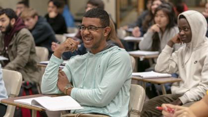 Student sitting at a desk and laughing