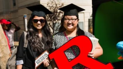 Two Newark graduates hold a block R sign