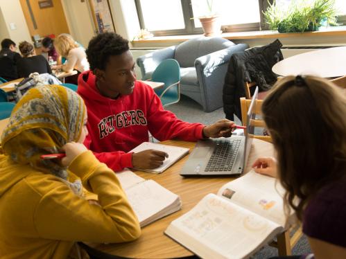 A group of students works together at a table