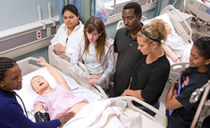 Nursing students practice on dummy patient